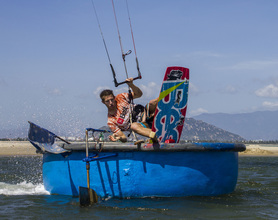 Chris Bobryk stalling on a fishing boat kiteboarding/kitesurfing Phan Rang, Vietnam, mui ne, windy, comekitewithus 